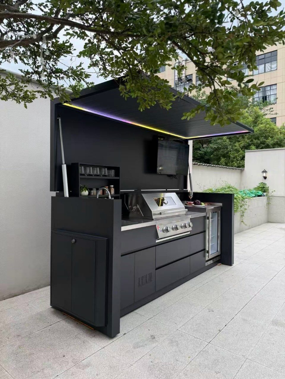 Backyard Barbeque Design: 12 BBQ Island Ideas for Outdoor Cooking 11 Matte black compact outdoor kitchen with a built-in grill, refrigerator, and LED lighting under a canopy.