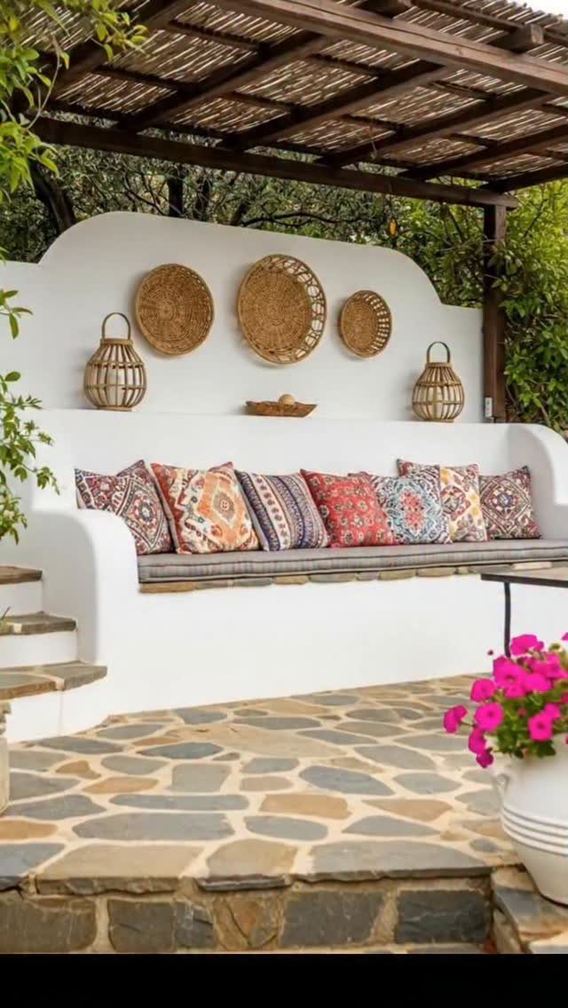 13 Backyard Entertaining Area Ideas for Every Season 10 Patterned cushions on a white built-in sofa with woven wall decor and lanterns.