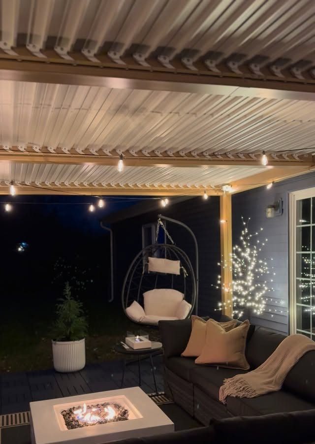 20 Covered Patio Ideas for Shade, Style and Year-Round Use 5 String lights hanging under a metal patio cover above a dark outdoor lounge area.