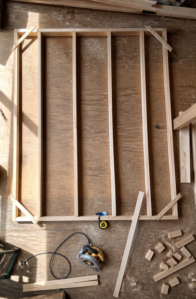How to Build a Shed: 7 Steps From Foundation to Finished Exterior 3 Framed side walls of the shed laid flat on the floor.