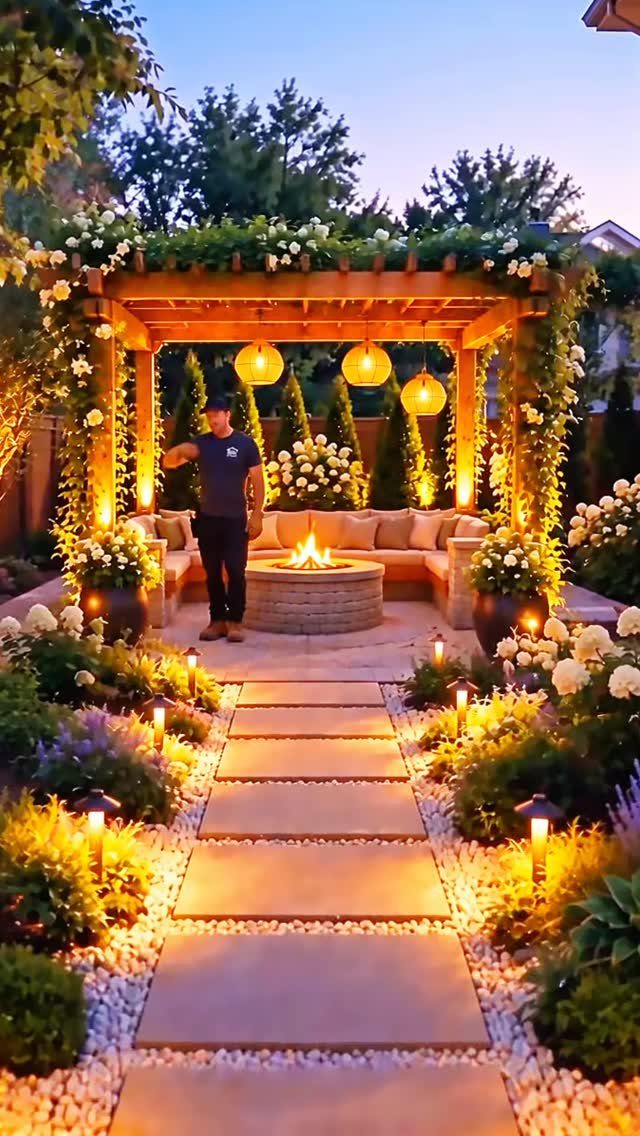 29 Outdoor Gardens Ideas for Patios, Yards, and Every Budget 1 A lit firepit serves as a centerpiece within a beautifully landscaped outdoor living space.