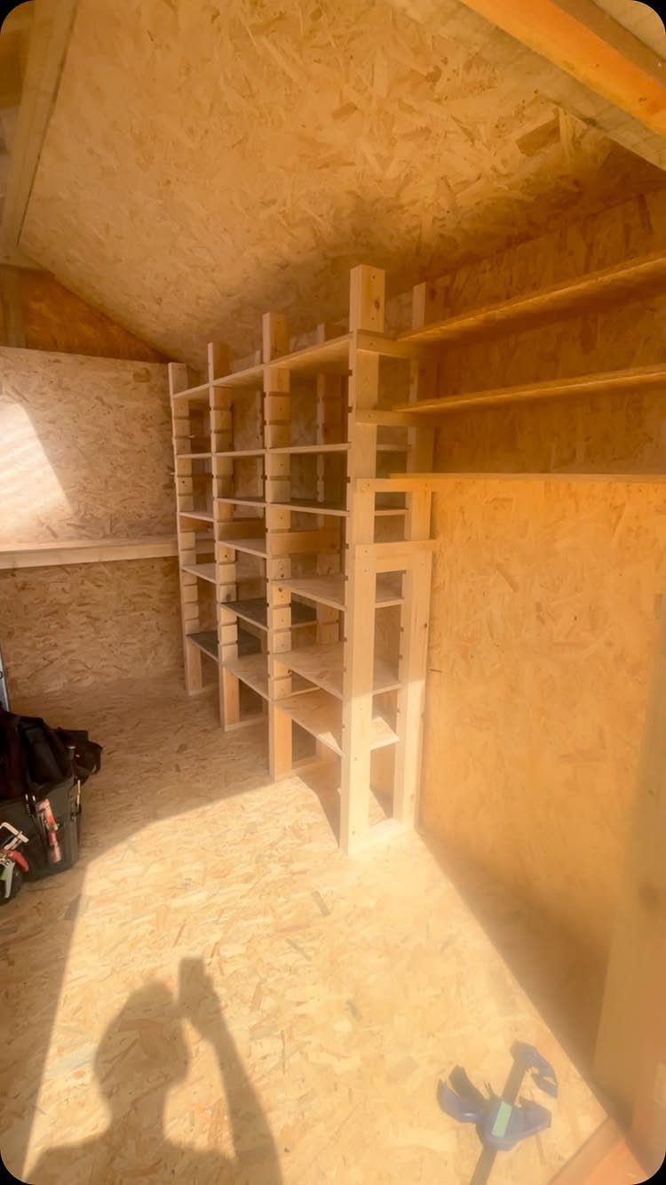 Tool Shed Storage: 12 Ideas for Lawn Gear, Power Tools & Hardware 3 Wooden shelving units built into the interior walls of an empty OSB tool shed.