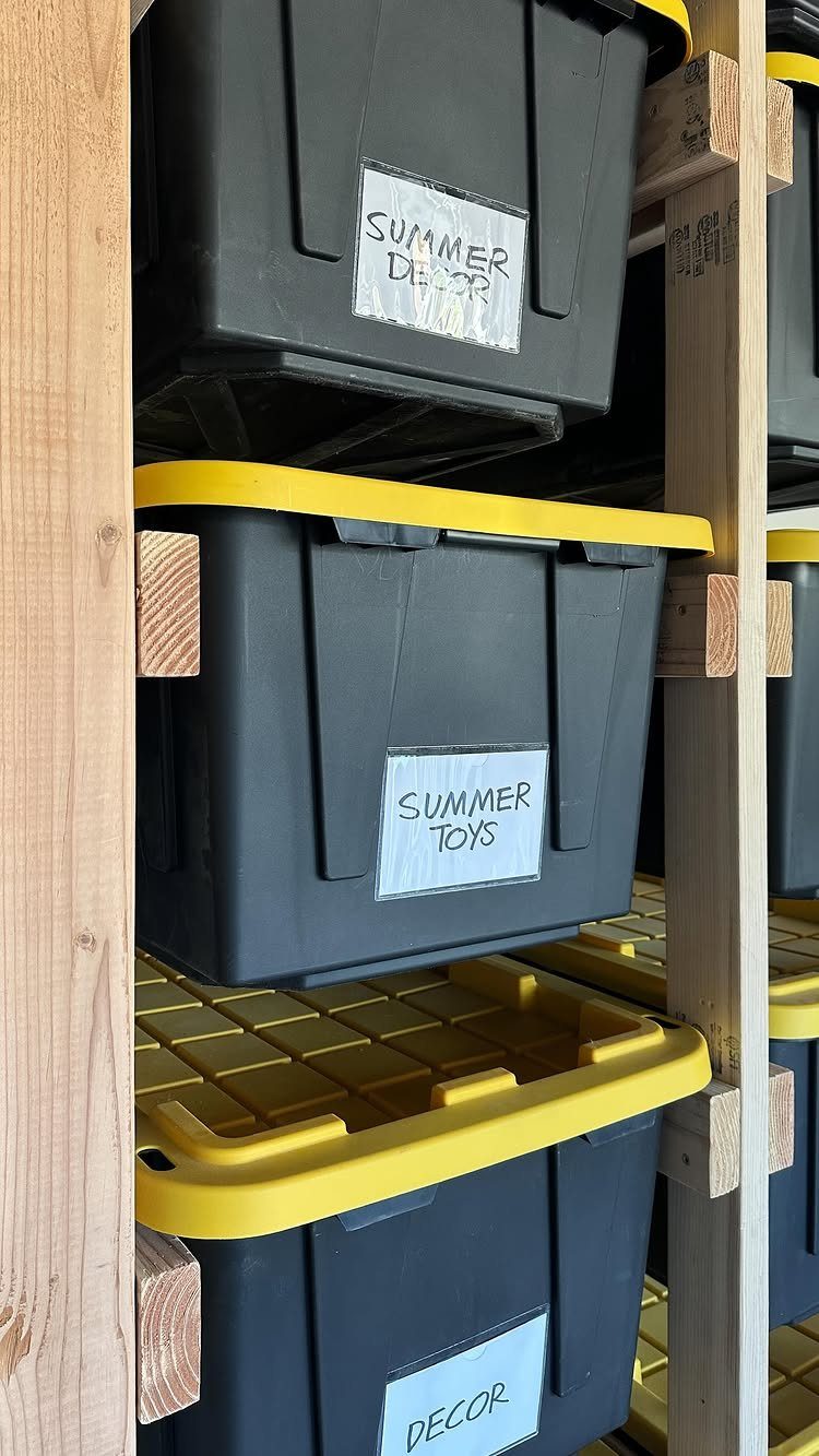 Tool Shed Storage: 12 Ideas for Lawn Gear, Power Tools & Hardware 5 Black and yellow storage bins with handwritten labels sit on a wooden shelf unit.