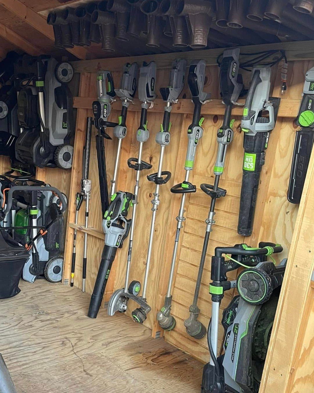 Tool Shed Storage: 12 Ideas for Lawn Gear, Power Tools & Hardware 1 Cordless garden power tools hanging organized on wooden slats inside a storage shed.