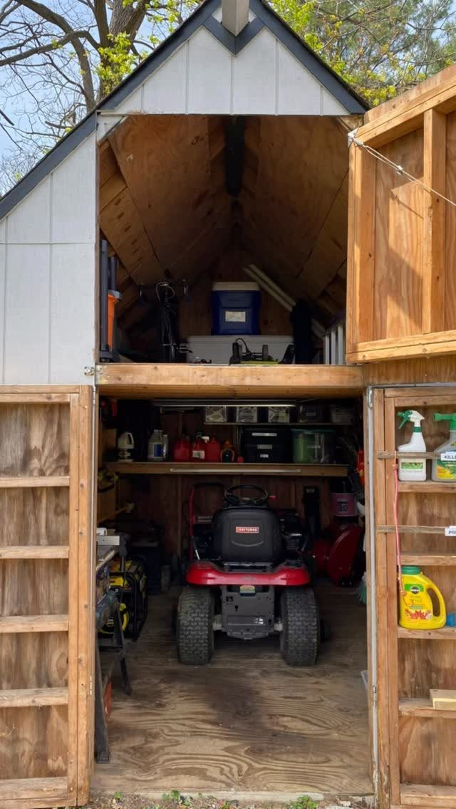 Tool Shed Storage: 12 Ideas for Lawn Gear, Power Tools & Hardware 8 Open wooden shed showing a riding mower and organized tool storage on multiple levels.